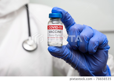 Coronavirus vaccine vial in doctor hand closeup Coronavirus vaccine vial in doctor hand closeup 78838535