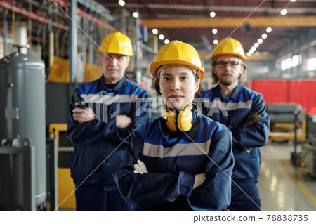 Portrait of female plant worker with colleagues Portrait of female plant worker with colleagues 78838735