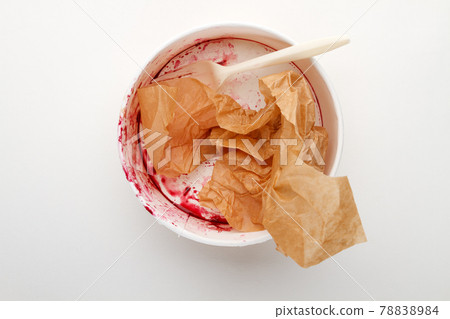 Dirty disposable bowl and fork after eating on a white background 78838984