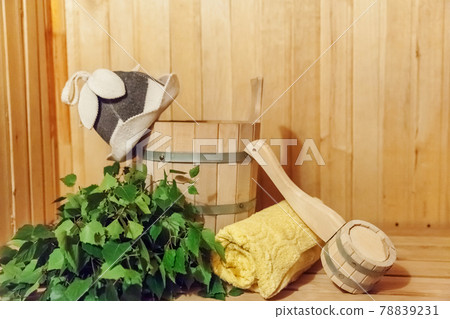 Interior details Finnish sauna steam room bathhouse with traditional sauna accessories basin birch broom scoop felt hat towel Interior details Finnish sauna steam room bathhouse with traditional sauna accessories basin birch broom scoop felt hat towel 78839231
