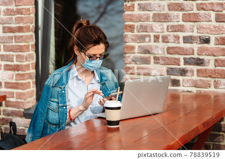 A young woman works remotely at a laptop during the Covid-19 pandemic A young woman works remotely at a laptop during the Covid-19 pandemic 78839519