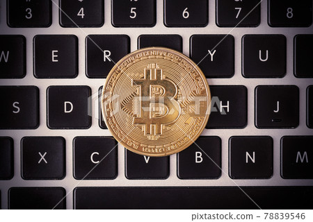Golden coins with bitcoin symbol on keyboard Golden coins with bitcoin symbol on keyboard 78839546