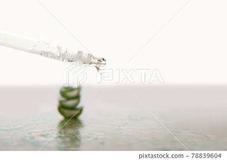 Pipette and aloe vera in serum gel with oxygen bubbles close up 78839604