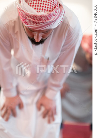 group of muslim people praying namaz in mosque. 78840016