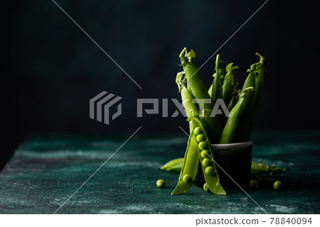Fresh pea pods on green background 78840094