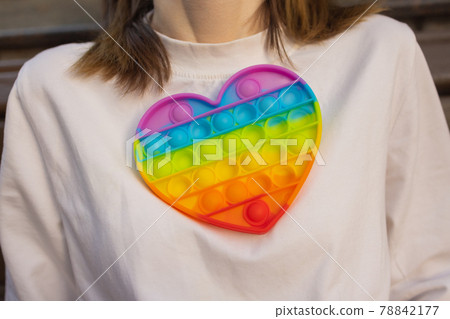 Woman using pop it fidget toy closeup. Woman using pop it fidget toy closeup. 78842177