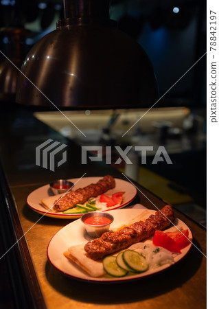 Delicious seekh kabab served in plate at table. Delicious seekh kabab served in plate at table. 78842197