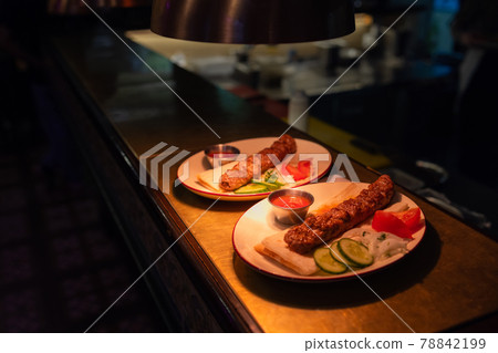 Delicious seekh kabab served in plate at table. Delicious seekh kabab served in plate at table. 78842199