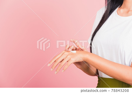 woman applying lotion cosmetic moisturizer cream on her behind the palm skin back hand woman applying lotion cosmetic moisturizer cream on her behind the palm skin back hand 78843208