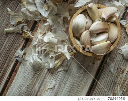 The garlic on wood table for food or cooking concept. The garlic on wood table for food or cooking concept. 78844058