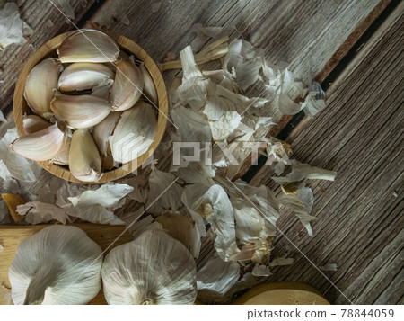 The garlic on wood table for food or cooking concept. The garlic on wood table for food or cooking concept. 78844059