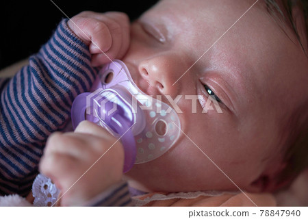 One month newborn baby sleeping in bed One month newborn baby sleeping in bed 78847940