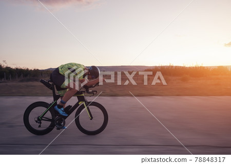 triathlon athlete riding a bike triathlon athlete riding a bike 78848317