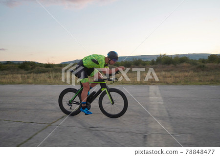 triathlon athlete riding a bike triathlon athlete riding a bike 78848477