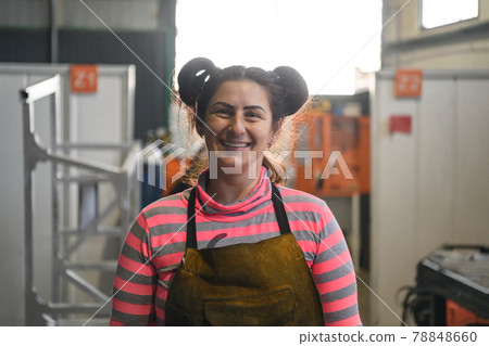 a portrait of a women welder holding a helmet and preparing for a working day in the metal industry 78848660