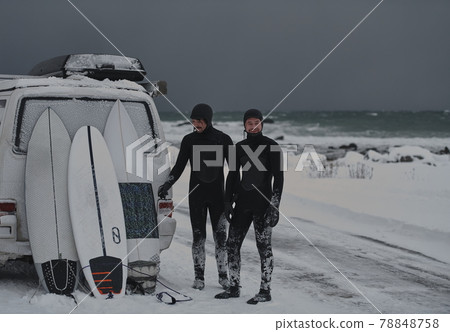 Arctic surfers in wetsuit after surfing by minivan 78848758