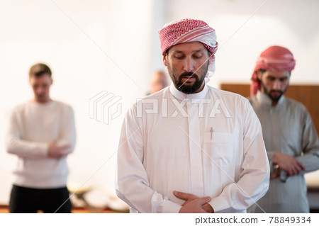 group of muslim people praying namaz in mosque. 78849334