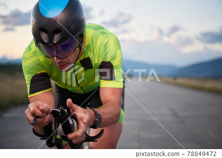 triathlon athlete riding a bike triathlon athlete riding a bike 78849472