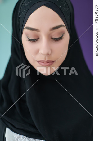 Portrait of Arab woman in traditional clothes using mobile phone. Portrait of Arab woman in traditional clothes using mobile phone. 78850537