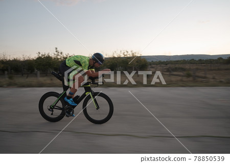 triathlon athlete riding a bike triathlon athlete riding a bike 78850539