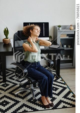 Woman tired after work at office Woman tired after work at office 78850821