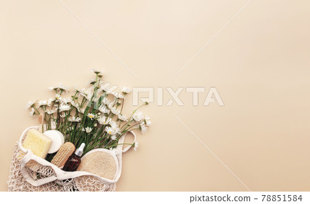 Eco friendly beige flat lay with shopping bag, flowers, bath accessories Eco friendly beige flat lay with shopping bag, flowers, bath accessories 78851584