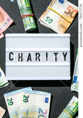 Lightbox board with word CHARITY in black letters around Euro banknotes. Money, Business, finance, investment, saving Lightbox board with word CHARITY in black letters around Euro banknotes. Money, Business, finance, investment, saving 78851726