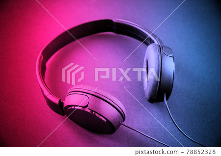 Headphones on a pink to blue gradient background Headphones on a pink to blue gradient background 78852328