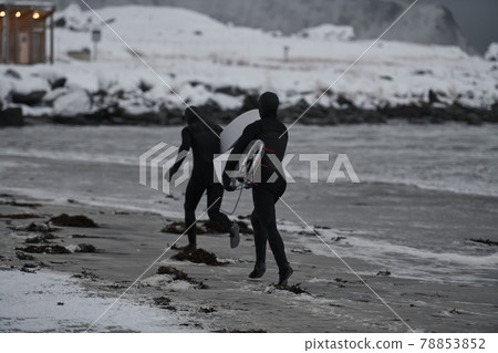 Arctic surfers running on beach after surfing Arctic surfers running on beach after surfing 78853852