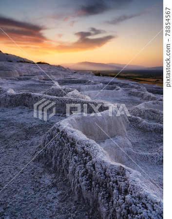 Summer landscape during sunset. The view of the travertines and the bright sunset. 78854567