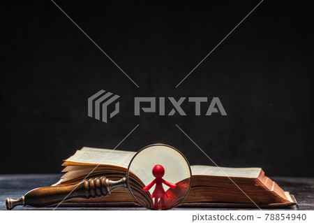 A book with a figure of a women visible through a magnifying glass. Knowledge and Education Concept A book with a figure of a women visible through a magnifying glass. Knowledge and Education Concept 78854940