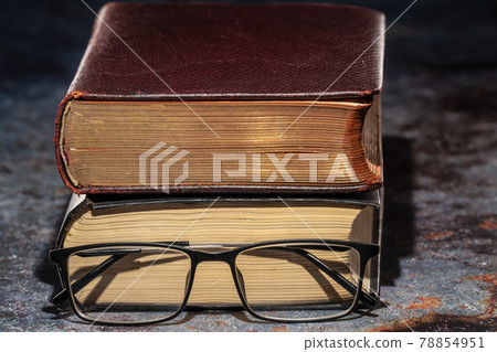 An old book with glasses. Knowledge and Education Concept An old book with glasses. Knowledge and Education Concept 78854951