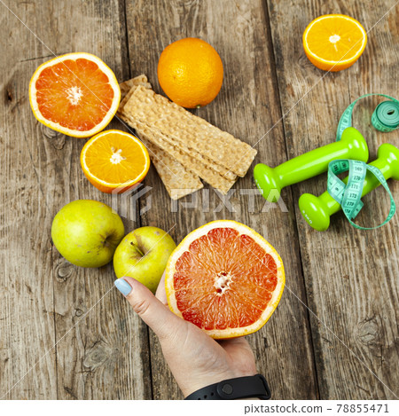 Female hands hold a grapefruit Female hands hold a grapefruit 78855471