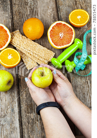 Woman holds an apple in her hands. Woman holds an apple in her hands. 78855473