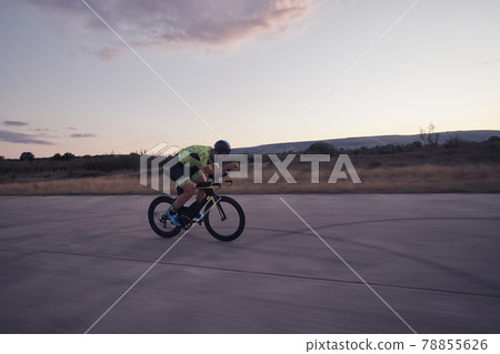 triathlon athlete riding a bike triathlon athlete riding a bike 78855626