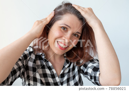 Young woman shows her gray hair roots. Early aging concept. Young woman shows her gray hair roots. Early aging concept. 78856021