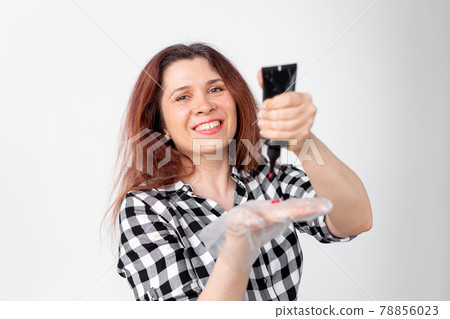 Young woman dyes her hair at home. Bright hair coloring concept. Young woman dyes her hair at home. Bright hair coloring concept. 78856023