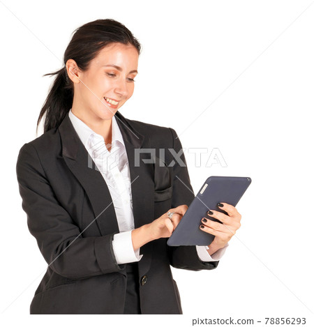 Caucasian business woman in a black suit with a smile and typing on a tablet mobile phone. Portrait on white background with studio light. Caucasian business woman in a black suit with a smile and typing on a tablet mobile phone. Portrait on white background with studio light. 78856293