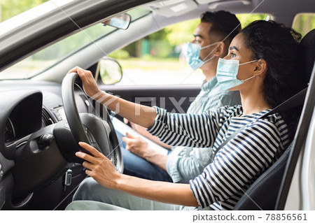 Young lady attending driving school during COVID-19 pandemic 78856561