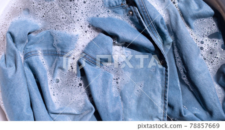 Jean shirt soak in powder detergent water dissolution, washing  cloth. Laundry concept 78857669
