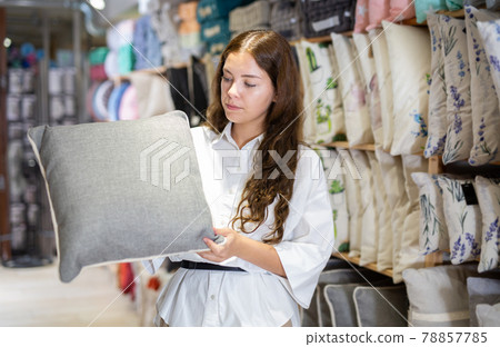 Woman choosing pillow in home textile shop 78857785