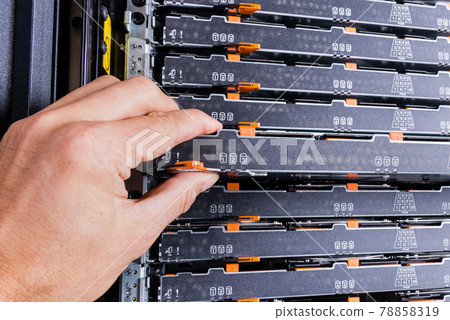 network administrator pulling data storage hardware from sever r 78858319