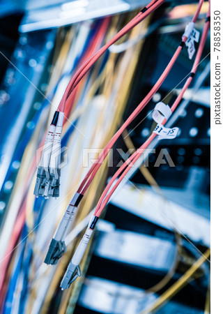 Detail of server room with bunch of fiber optic cables at the ba Detail of server room with bunch of fiber optic cables at the ba 78858350