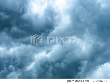 Thick dark black storm clouds covering summer sunset sky with gale-speed wind blowing just before Nor'westers Kalbaishakhi Bordoisila thunderstorm torrential rain. Atmospheric Texture background. Thick dark black storm clouds covering summer sunset sky with gale-speed wind blowing just before Nor'westers Kalbaishakhi Bordoisila thunderstorm torrential rain. Atmospheric Texture background. 78858787