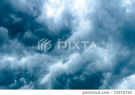 Thick dark black storm clouds covering summer sunset sky with gale-speed wind blowing just before Nor'westers Kalbaishakhi Bordoisila thunderstorm torrential rain. Atmospheric Texture background. Thick dark black storm clouds covering summer sunset sky with gale-speed wind blowing just before Nor'westers Kalbaishakhi Bordoisila thunderstorm torrential rain. Atmospheric Texture background. 78858788
