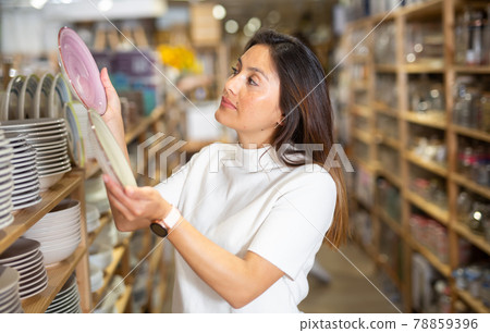 Woman selecting crockery in tableware store closeup 78859396