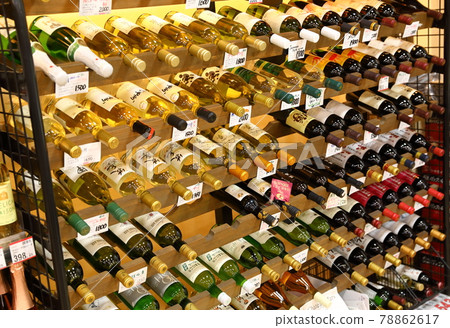 KAWAGUSHIGO, JAPAN - MAY 2018 : Assortment of wine bottles on shelf in a local supermarket, near Kawagushigo lake, Japan. KAWAGUSHIGO, JAPAN - MAY 2018 : Assortment of wine bottles on shelf in a local supermarket, near Kawagushigo lake, Japan. 78862617