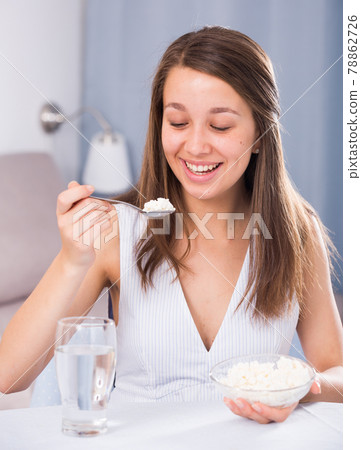 Girl is enjoying tasty curd Girl is enjoying tasty curd 78862726