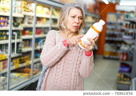 Shocked woman shopping in grocery Shocked woman shopping in grocery 78862856