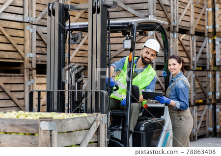 Distribution, loading of fruits for sale in store and market, work in warehouse during harvest season Distribution, loading of fruits for sale in store and market, work in warehouse during harvest season 78863408